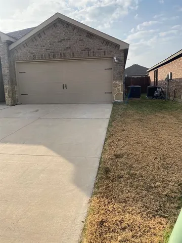 a view of a house with a wooden fence