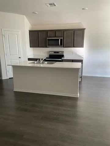 a kitchen with granite countertop a stove and a sink