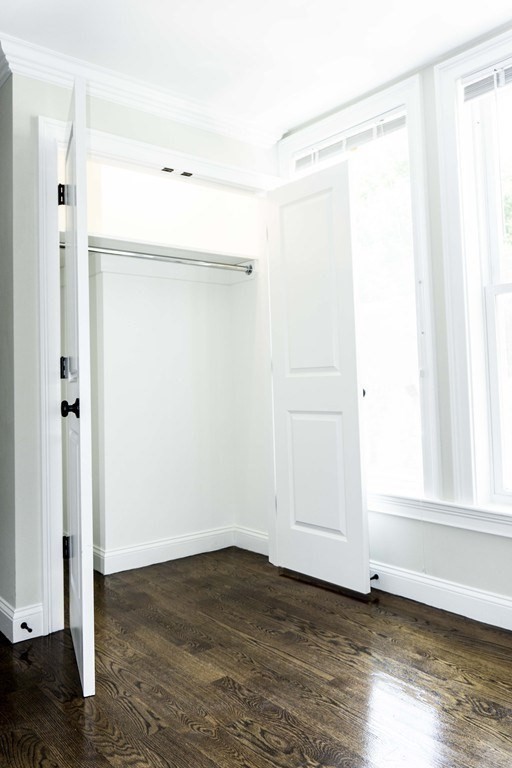 41 West Walnut Park Boston, MA 02119 - Photo 13 of 30 a view of an empty room with wooden floor and a window