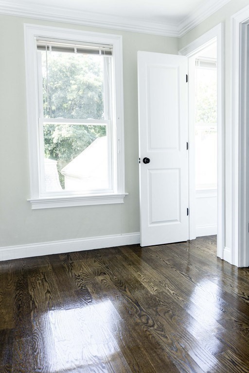 41 West Walnut Park Boston, MA 02119 - Photo 14 of 30 a view of an empty room with wooden floor and a window
