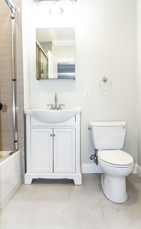 41 West Walnut Park Boston, MA 02119 - Photo 15 of 30 a white toilet sitting next to a bathroom sink