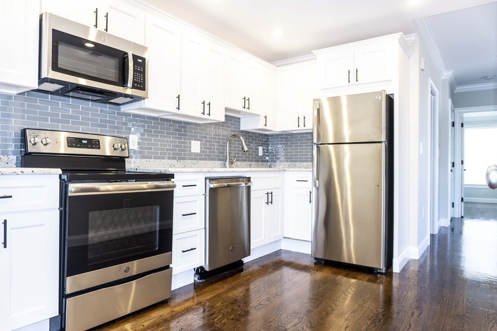 41 West Walnut Park Boston, MA 02119 - Photo 16 of 30 a kitchen with a stove microwave and refrigerator