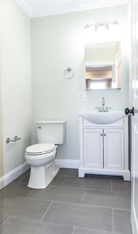 41 West Walnut Park Boston, MA 02119 - Photo 8 of 30 a bathroom with a white toilet sink vanity and mirror