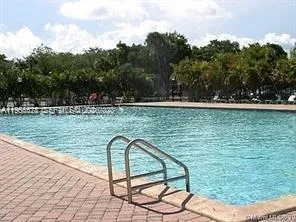 a view of a swimming pool with a yard
