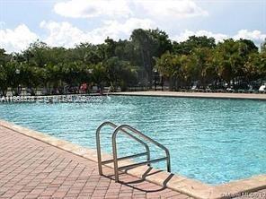 8520 Southwest 133rd Avenue Road, Unit 408 Miami, FL 33183 - Photo 10 of 10 a view of a swimming pool with a yard