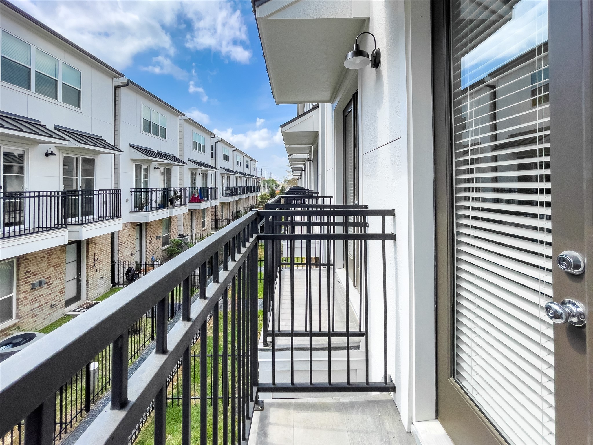 1276 North Post Oak Road, Unit B Houston, TX 77055 - Photo 18 of 33 Charming Juliet balconies extend from the living room.