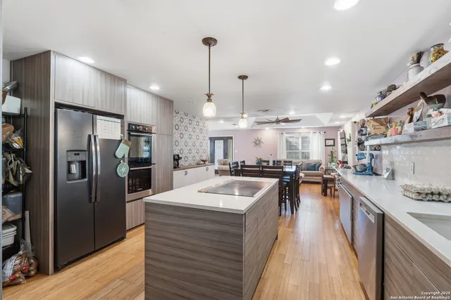 a kitchen with a refrigerator a sink and a stove