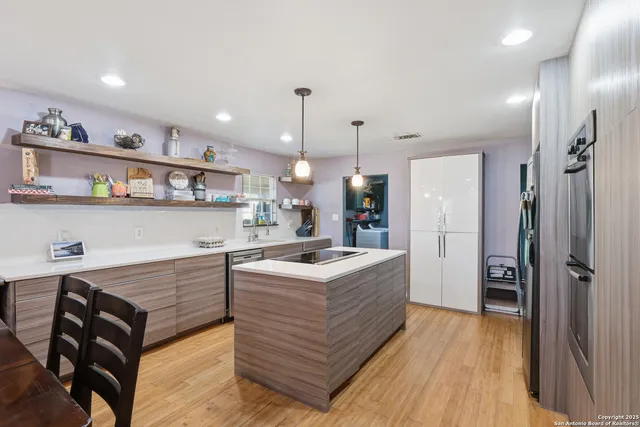 a kitchen with a stove and a refrigerator