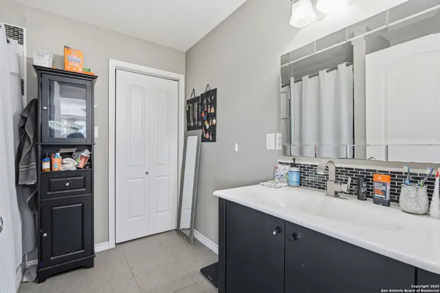 a bathroom with a double vanity sink and mirror