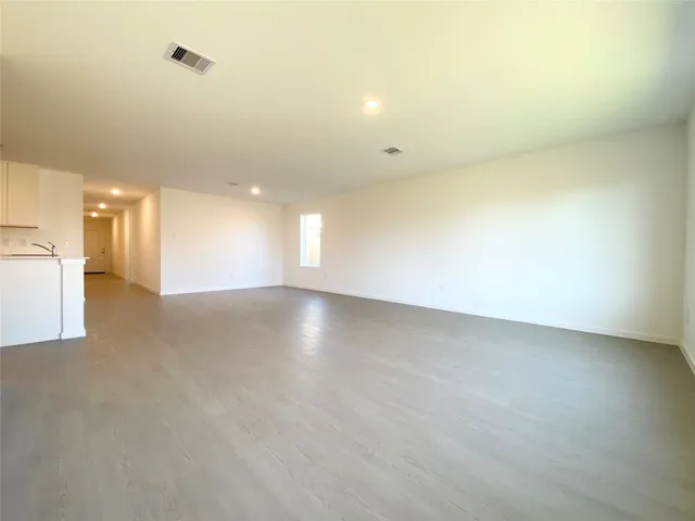 an empty room with a empty space and windows