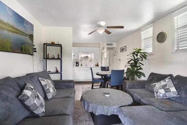 a living room with furniture and a chandelier