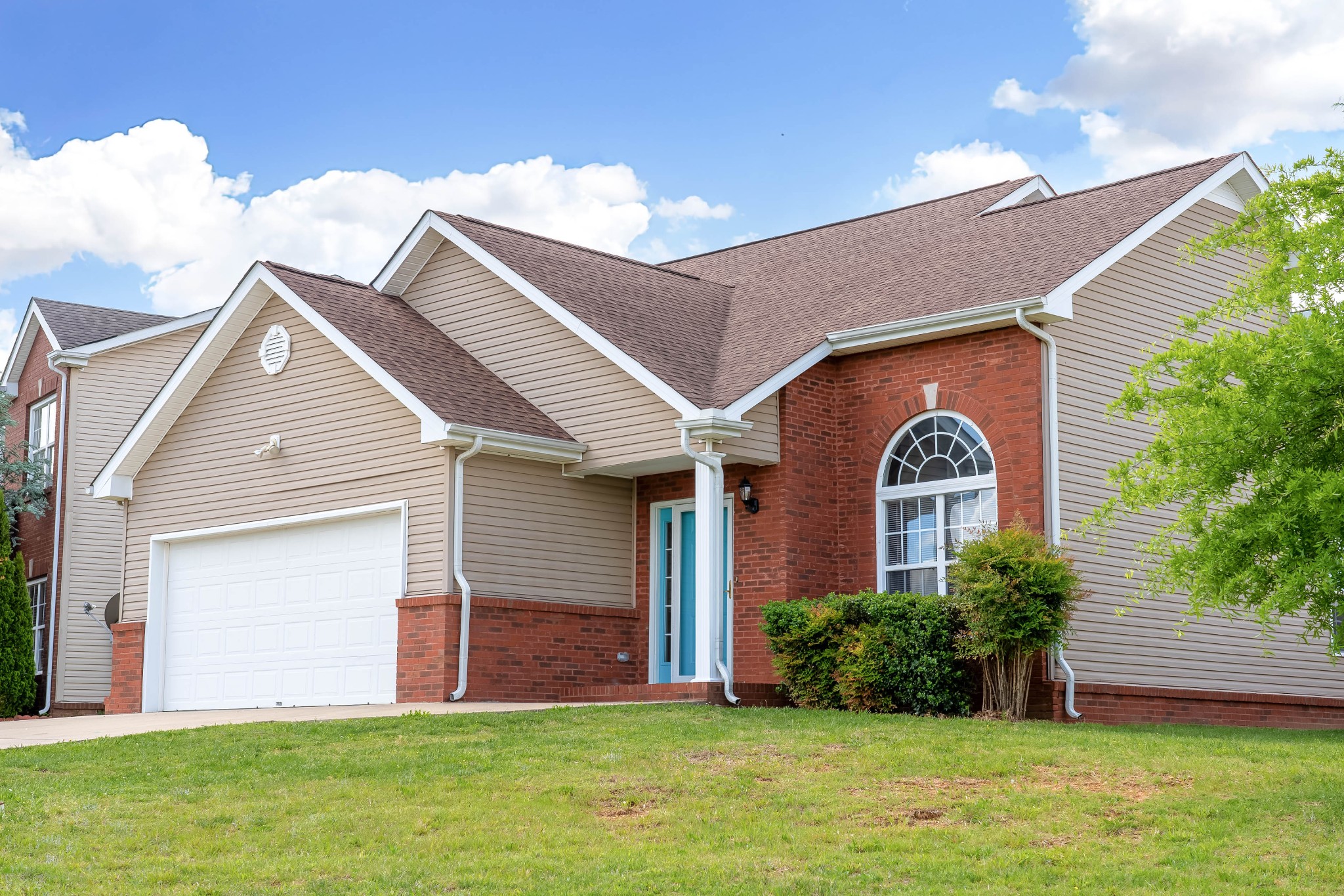 a front view of a house with a yard and garage