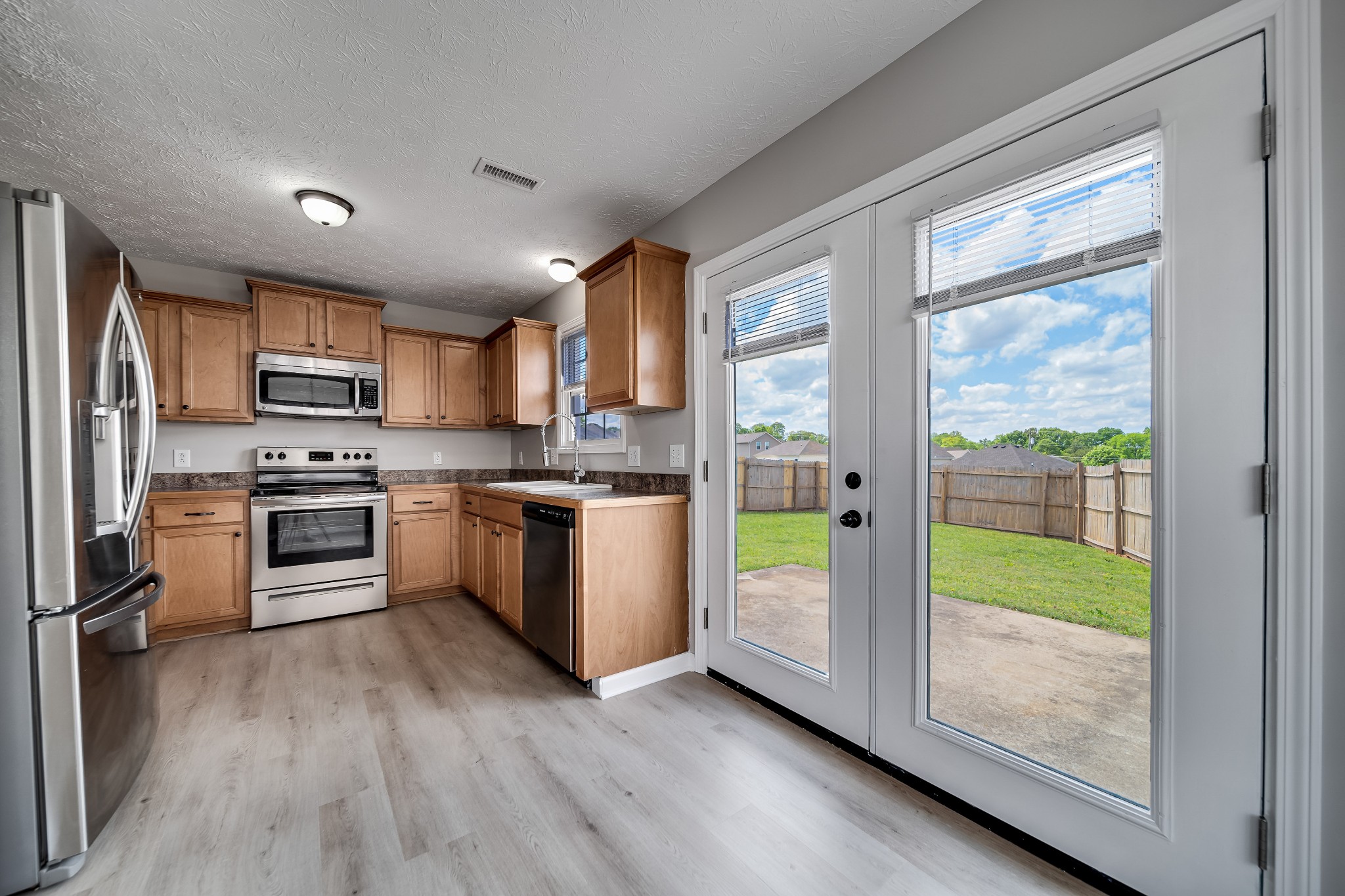 630 Berry Circle Springfield, TN 37172 - Photo 11 of 46 a kitchen with a refrigerator a sink and a stove top oven