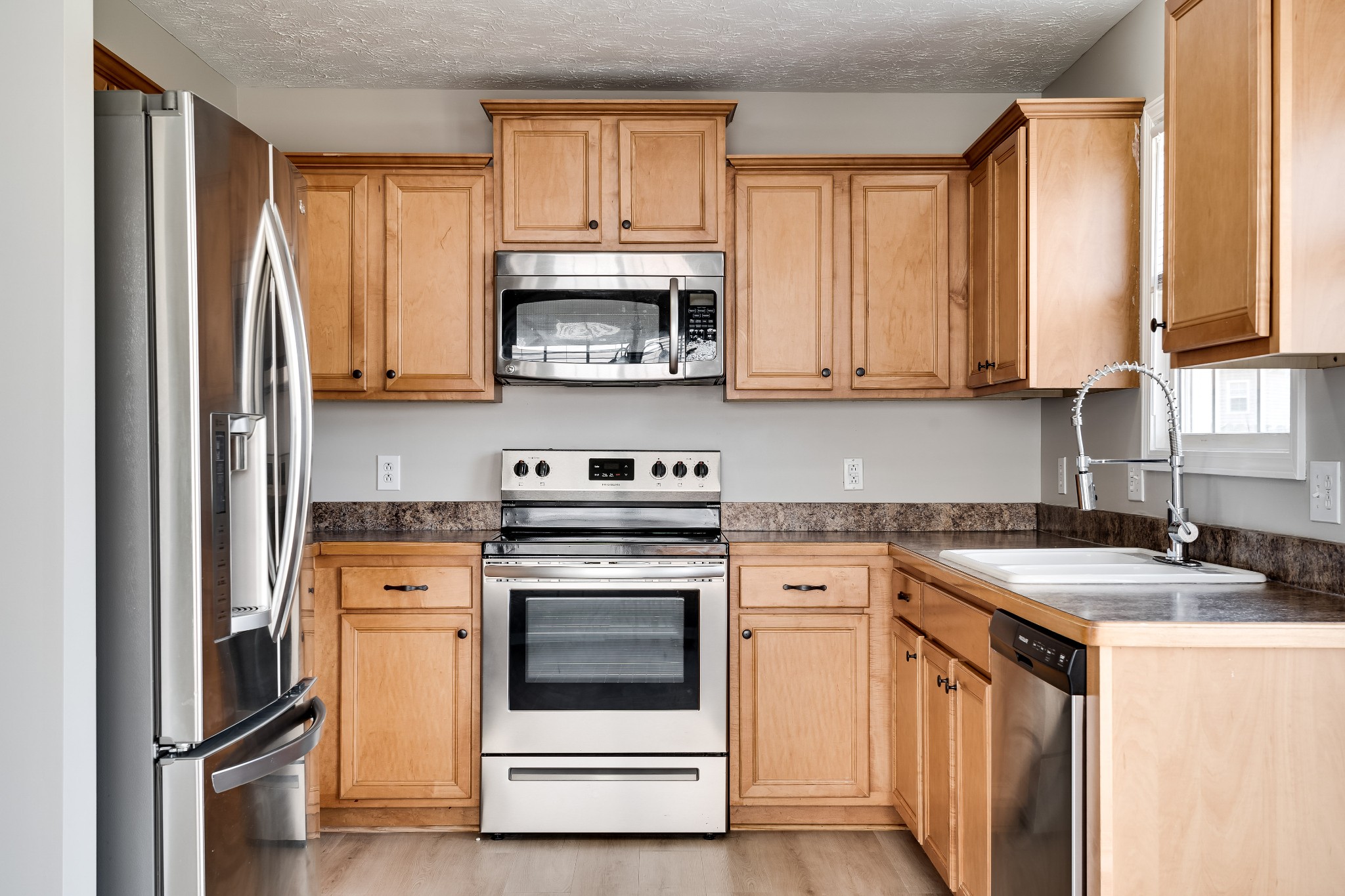 630 Berry Circle Springfield, TN 37172 - Photo 12 of 46 a kitchen with stainless steel appliances granite countertop a stove a sink and a microwave