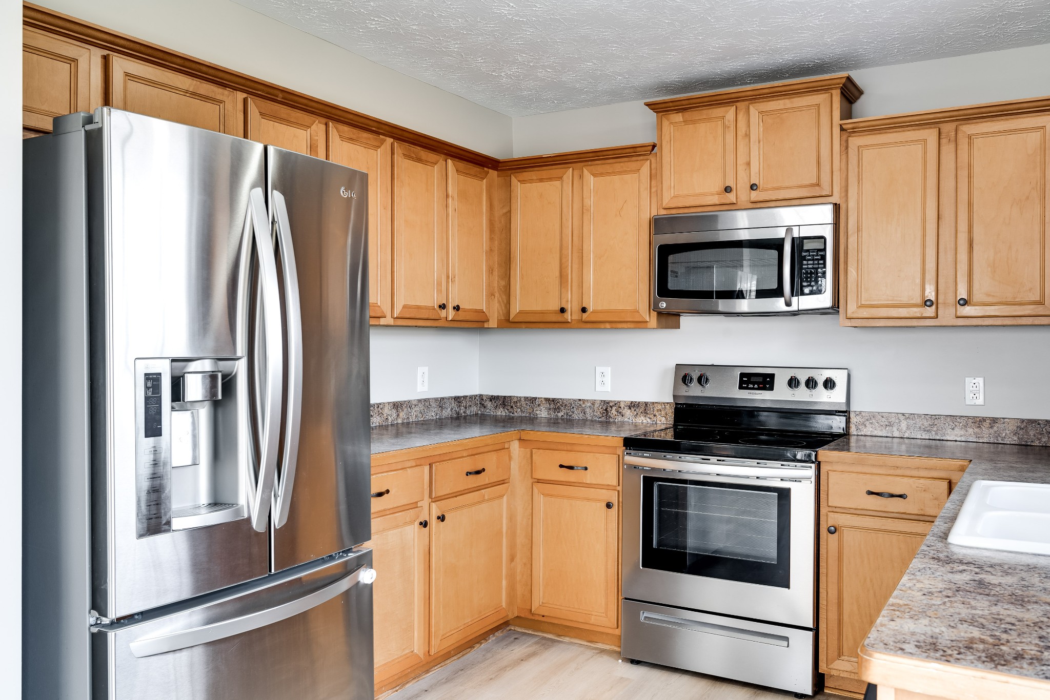 630 Berry Circle Springfield, TN 37172 - Photo 13 of 46 a kitchen with stainless steel appliances granite countertop a refrigerator stove and microwave