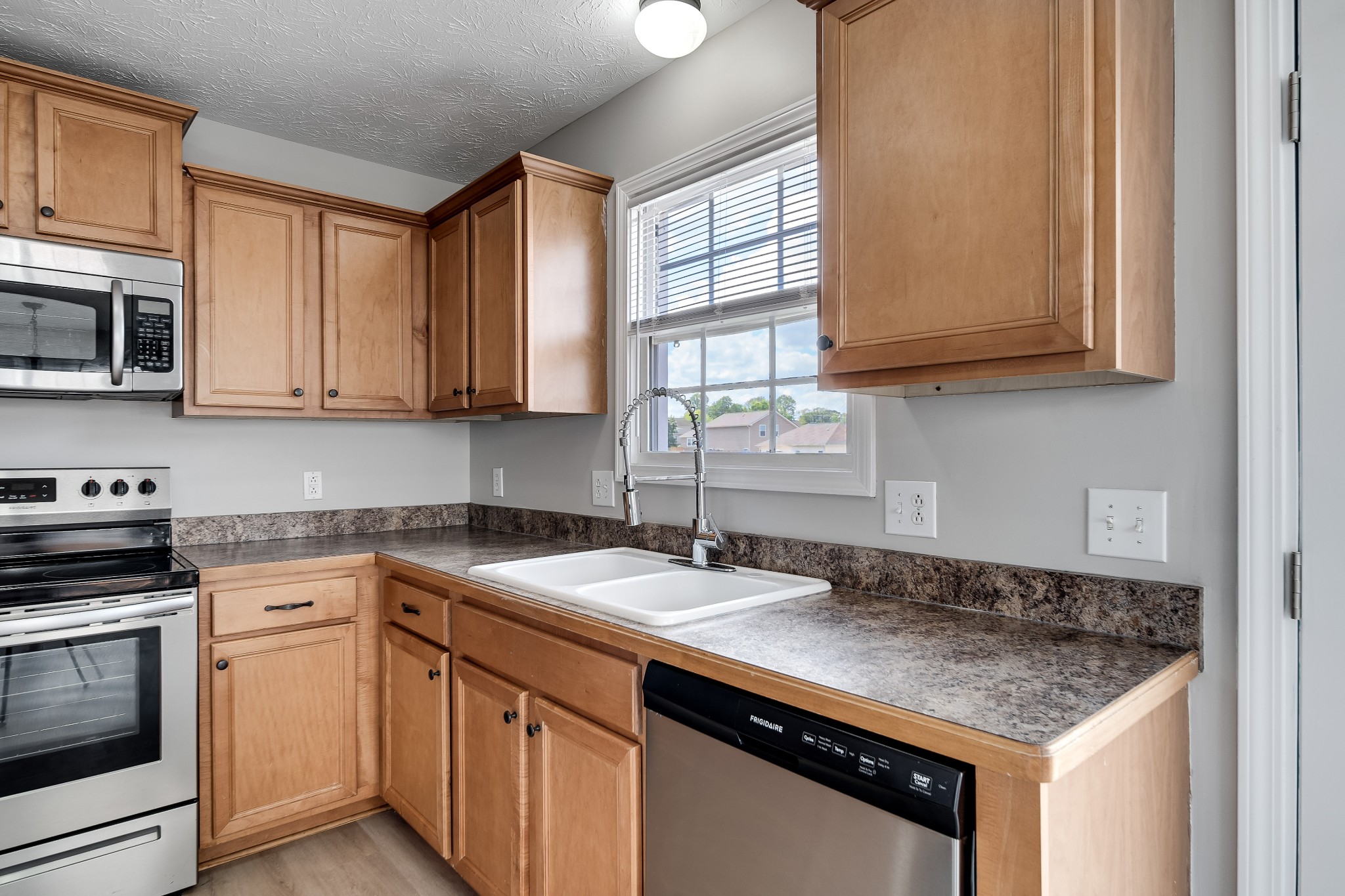 630 Berry Circle Springfield, TN 37172 - Photo 15 of 46 a kitchen with granite countertop a sink stove and cabinets