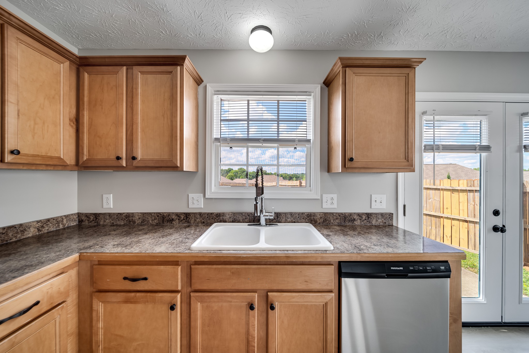 630 Berry Circle Springfield, TN 37172 - Photo 16 of 46 a kitchen with stainless steel appliances granite countertop a sink and a window