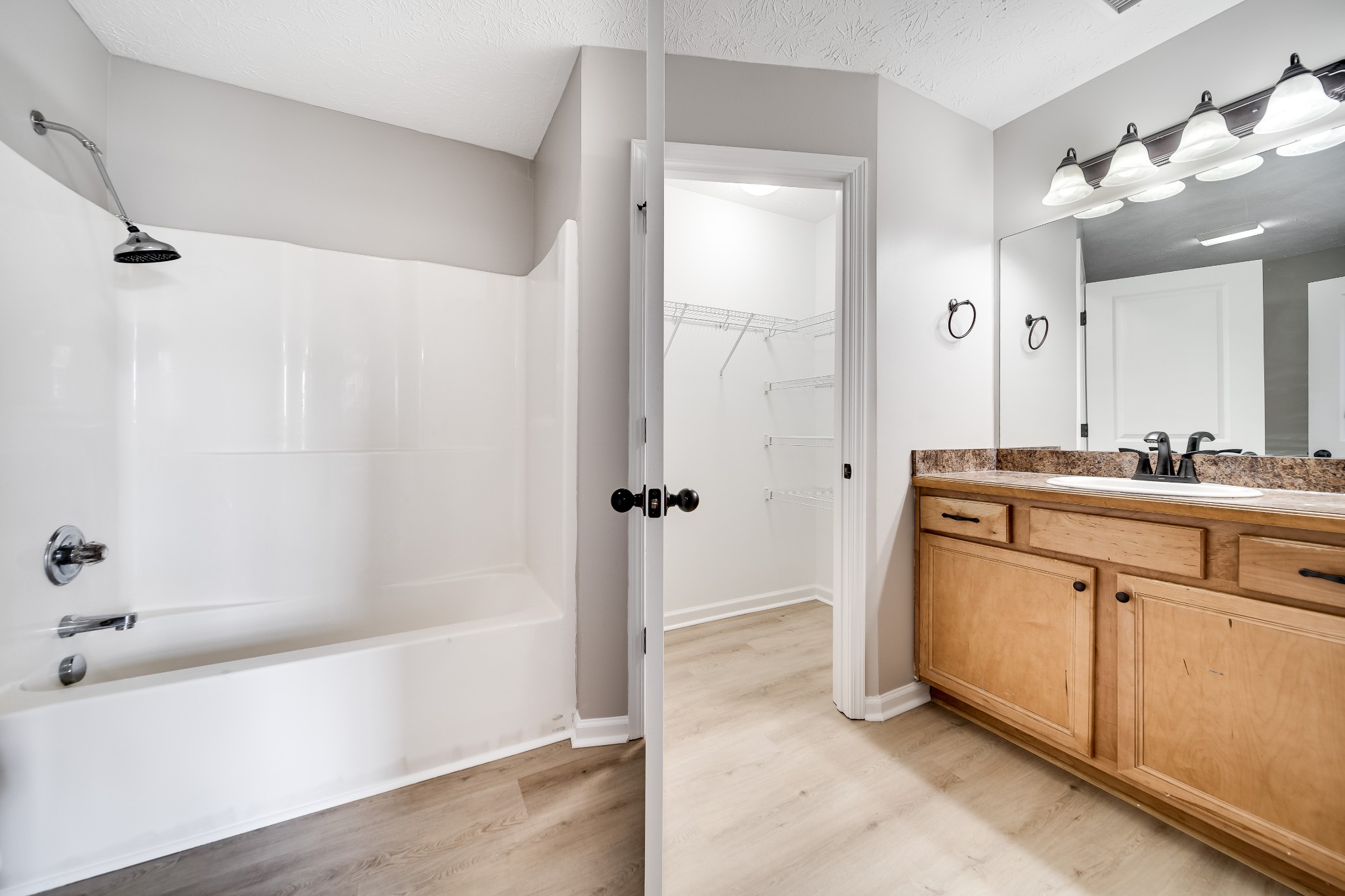 630 Berry Circle Springfield, TN 37172 - Photo 23 of 46 a bathroom with a granite countertop sink a mirror and a bathtub
