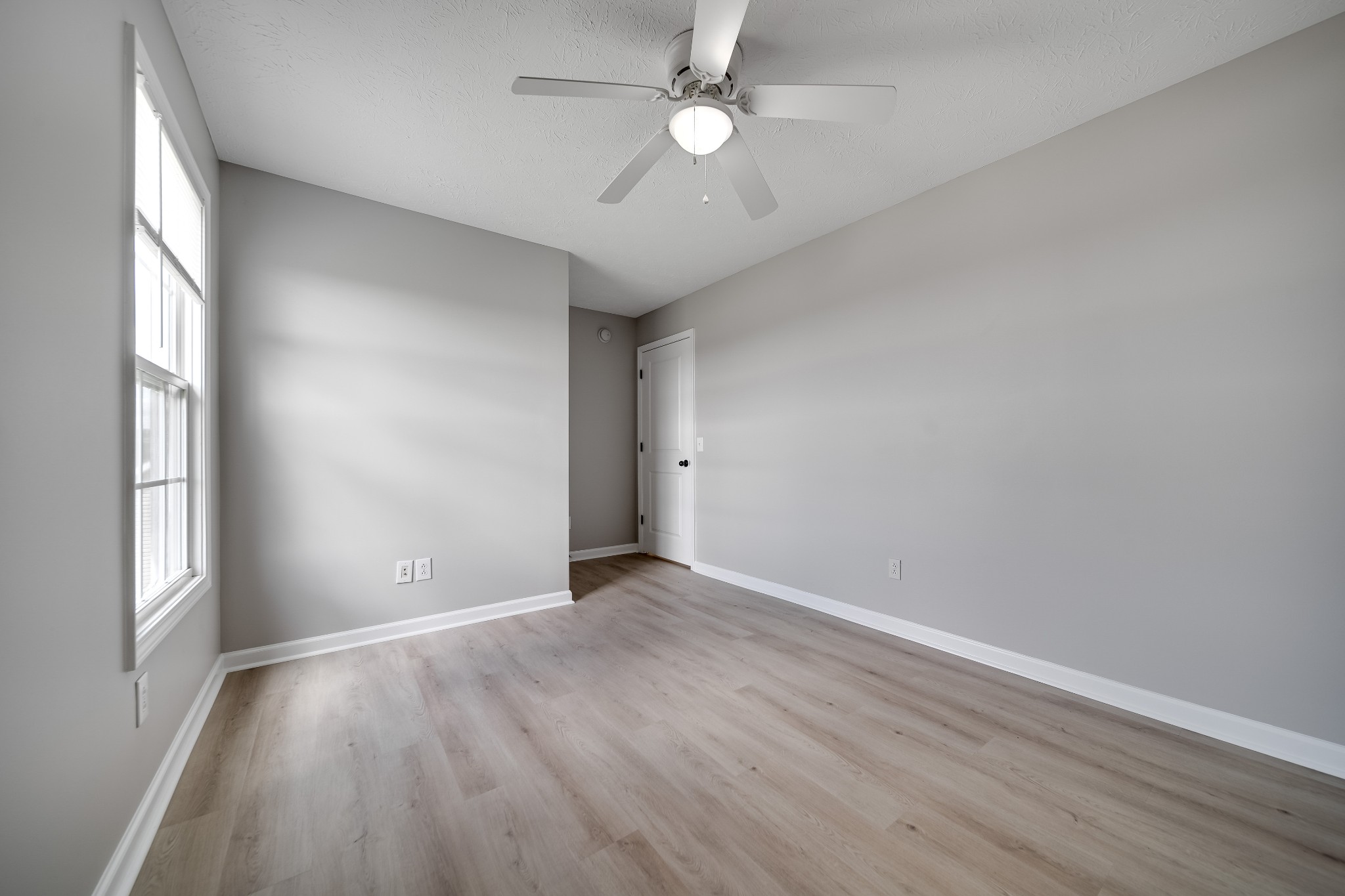 630 Berry Circle Springfield, TN 37172 - Photo 30 of 46 an empty room with wooden floor fan and windows