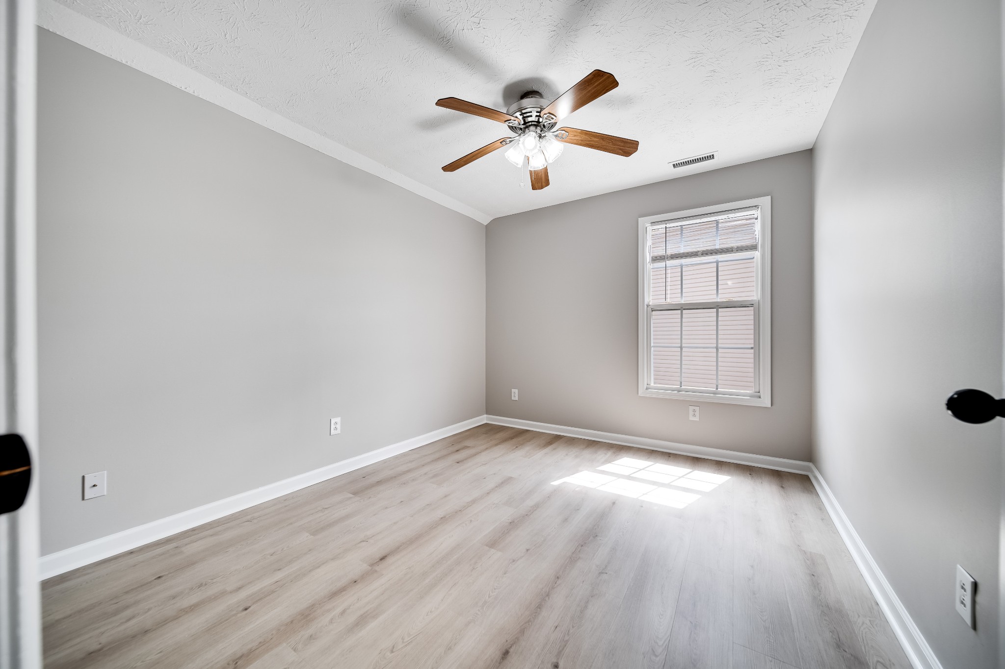 630 Berry Circle Springfield, TN 37172 - Photo 36 of 46 an empty room with wooden floor fan and windows