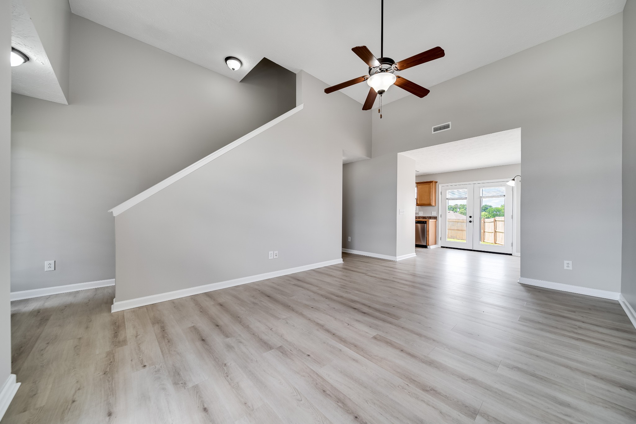 630 Berry Circle Springfield, TN 37172 - Photo 6 of 46 a view of an empty room with wooden floor and a ceiling fan