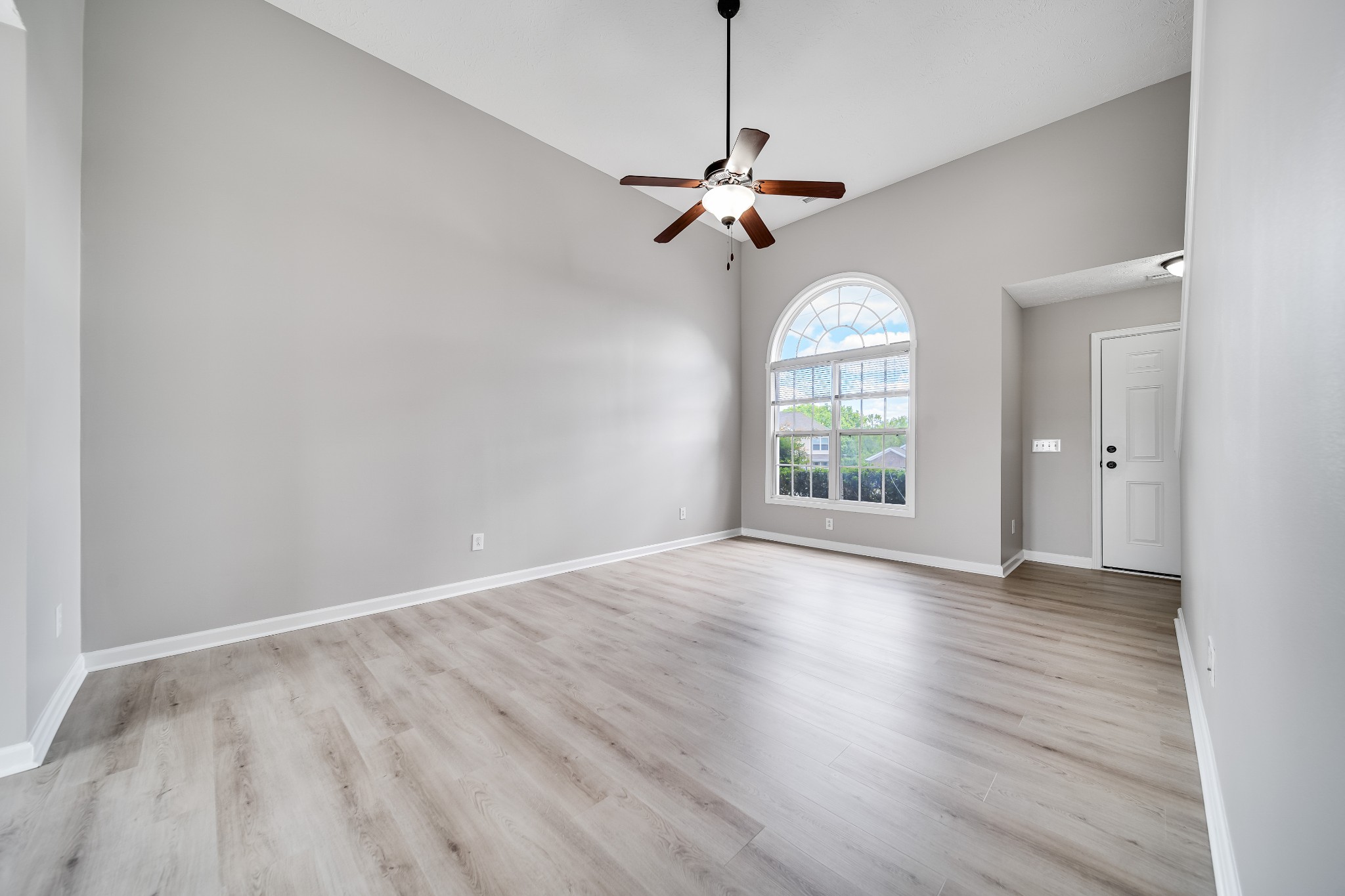 630 Berry Circle Springfield, TN 37172 - Photo 7 of 46 an empty room with wooden floor chandelier and windows