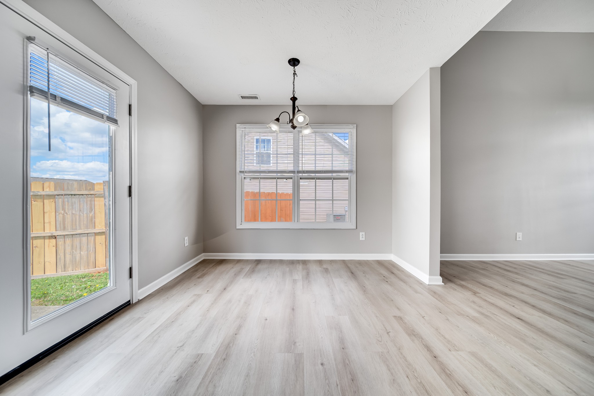 630 Berry Circle Springfield, TN 37172 - Photo 9 of 46 a view of an empty room with wooden floor and a window
