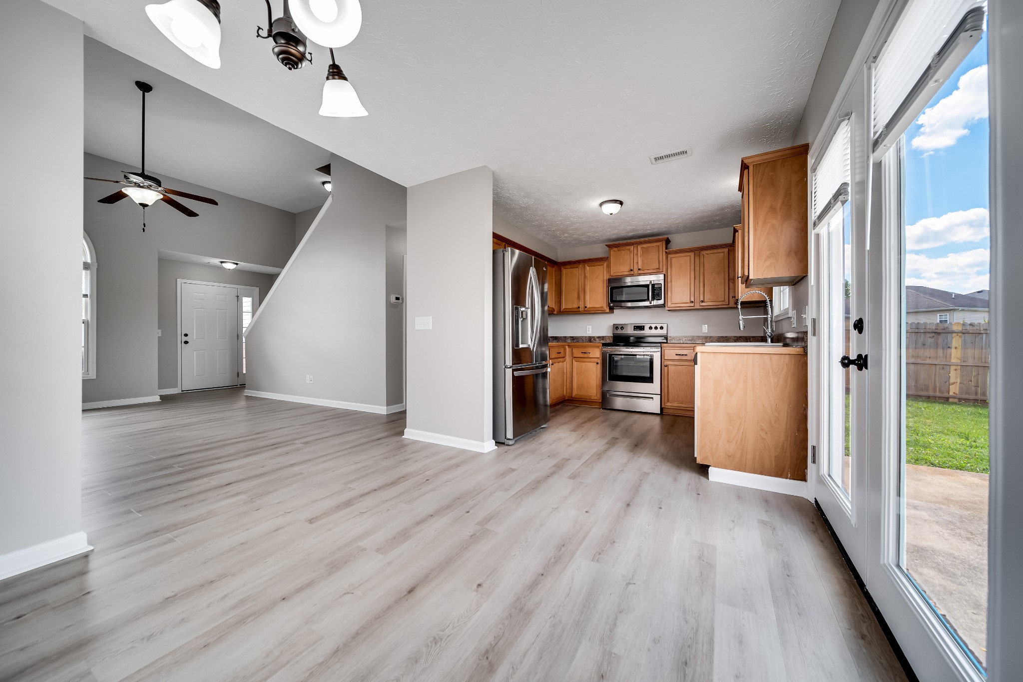 630 Berry Circle Springfield, TN 37172 - Photo 10 of 46 a view of kitchen with stainless steel appliances granite countertop a refrigerator oven a sink dishwasher and a refrigerator with wooden floor