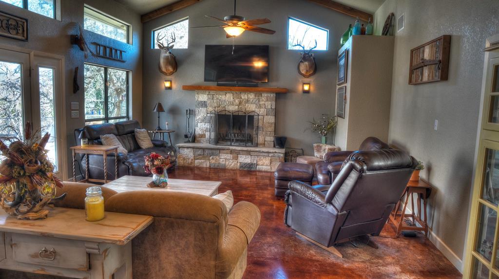 187 Roy Chisum Road Leakey, TX 78873 - Photo 12 of 40 a living room with furniture and a fireplace