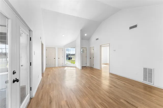 a view of a hallway with wooden floor