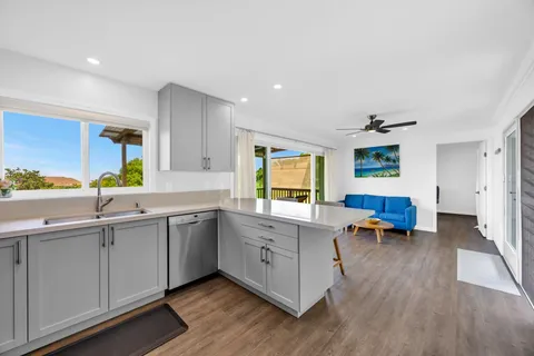 a kitchen with sink cabinets and wooden floor