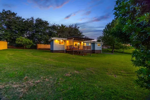 a house view with a play ground in front of it