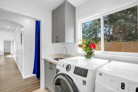 a view of washer and dryer with kitchen in the background