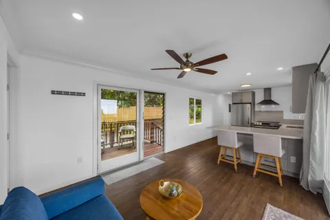 a living room with wooden floor and a window