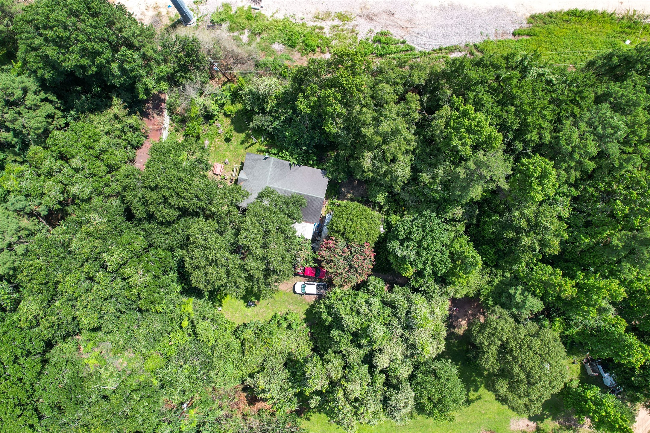 26028 Hardin Store Road Magnolia, TX 77354 - Photo 10 of 11 an aerial view of residential house with outdoor space and trees all around