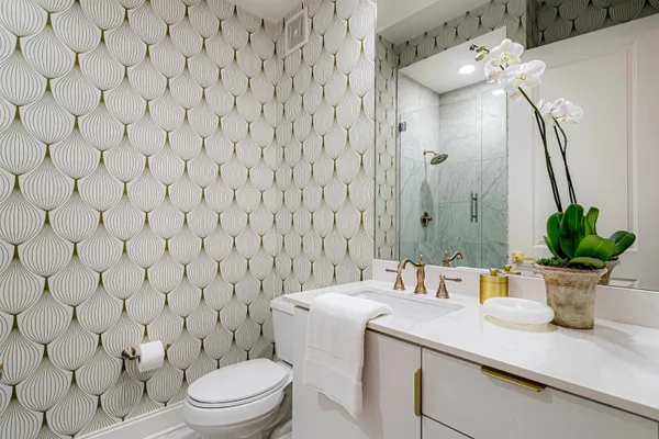 a bathroom with a sink a toilet and a mirror