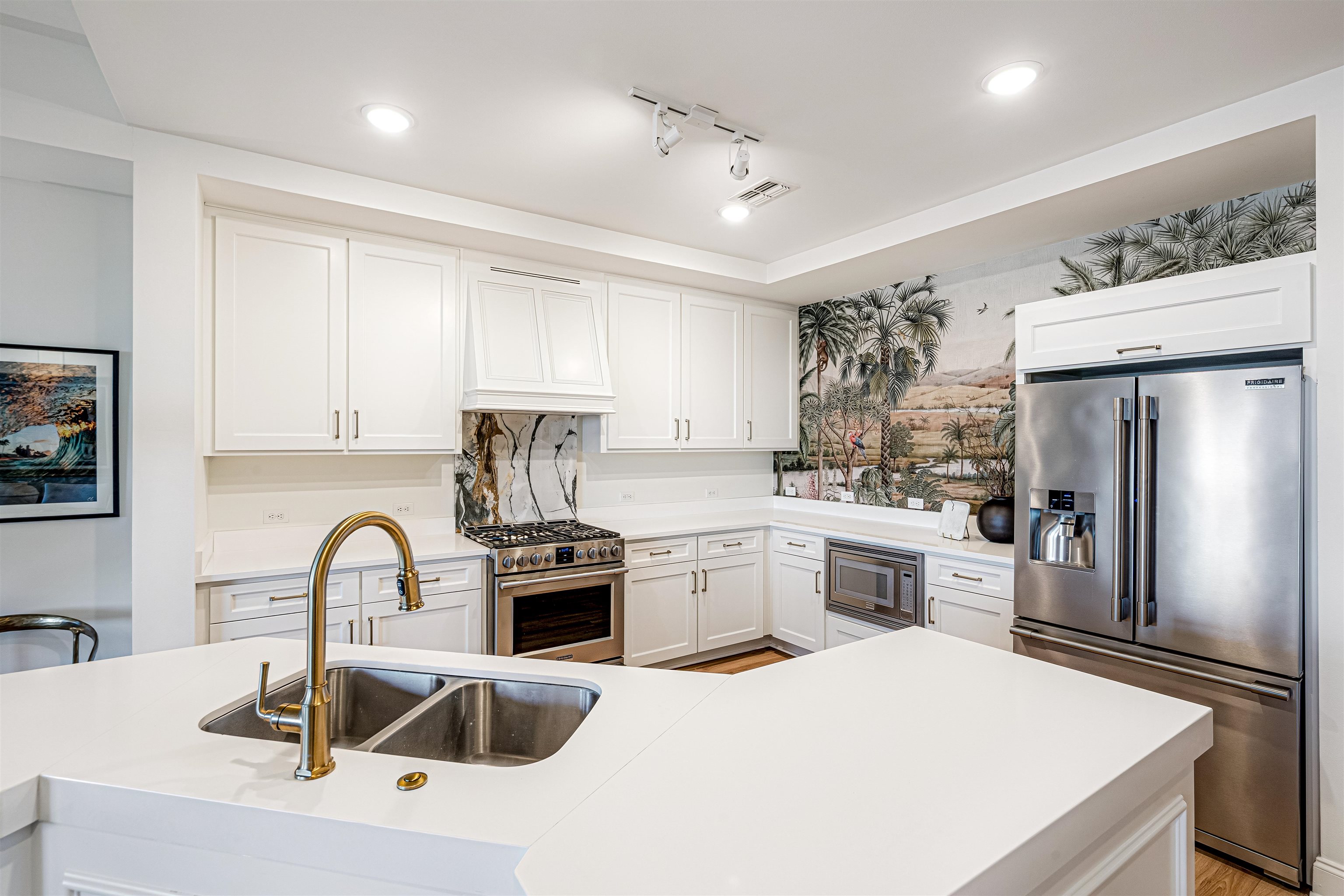 717 Riverside Drive, Unit 1205 Memphis, TN 38103 - Photo 33 of 33 a kitchen with granite countertop a sink stainless steel appliances and white cabinets