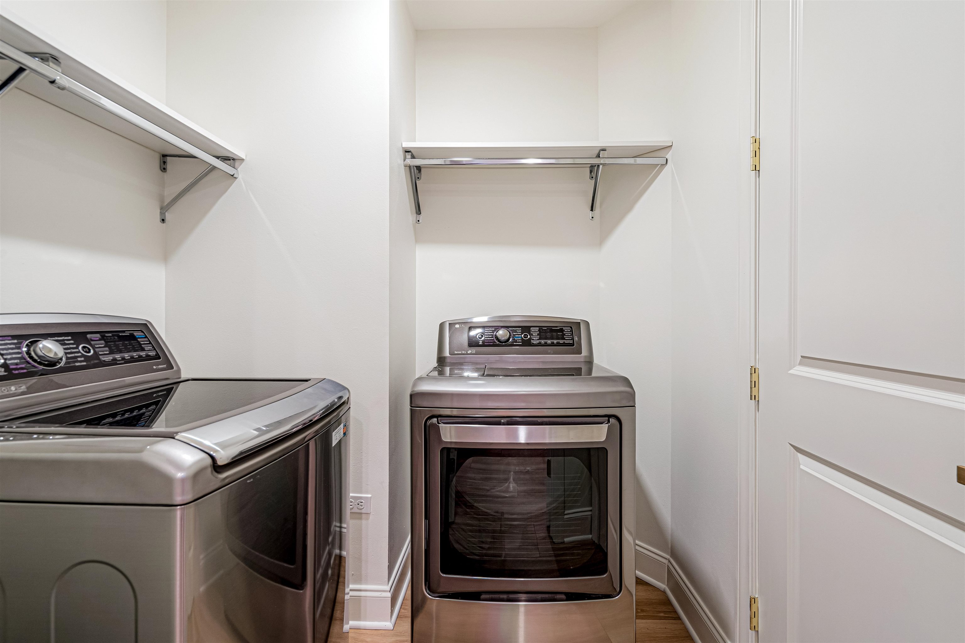 717 Riverside Drive, Unit 1205 Memphis, TN 38103 - Photo 8 of 33 Full Laundry room featuring washing machine and dryer and light wood-type flooring