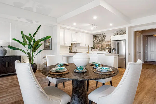 a view of a dining room with furniture and a potted plant