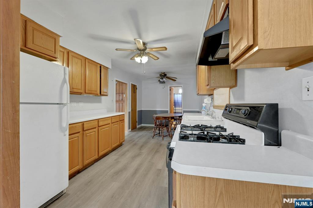 17 Butler Place Wanaque, NJ 07420 - Photo 13 of 28 a kitchen with stainless steel appliances a stove a sink and a refrigerator
