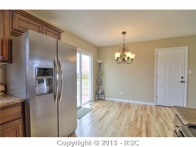 10865 Falling Star Road Fountain, CO 80817 - Photo 7 of 23 Dining room offers walk out to backyard, open to kitchen and living room.