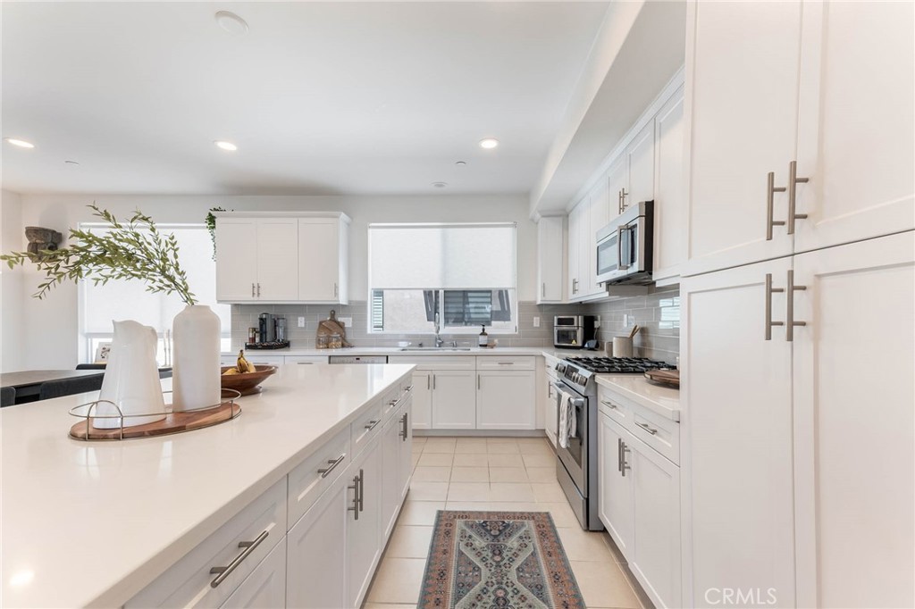 13161 Victory Boulevard Valley Glen, CA 91401 - Photo 11 of 33 a kitchen with a sink stove and cabinets