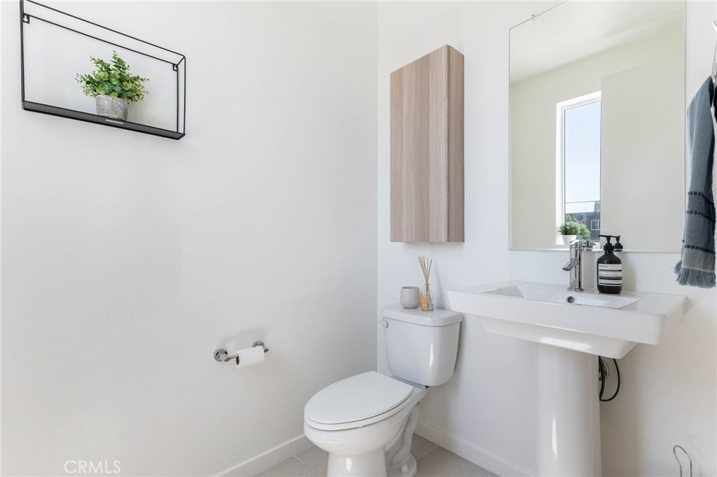 13161 Victory Boulevard Valley Glen, CA 91401 - Photo 18 of 33 a bathroom with a toilet sink and mirror