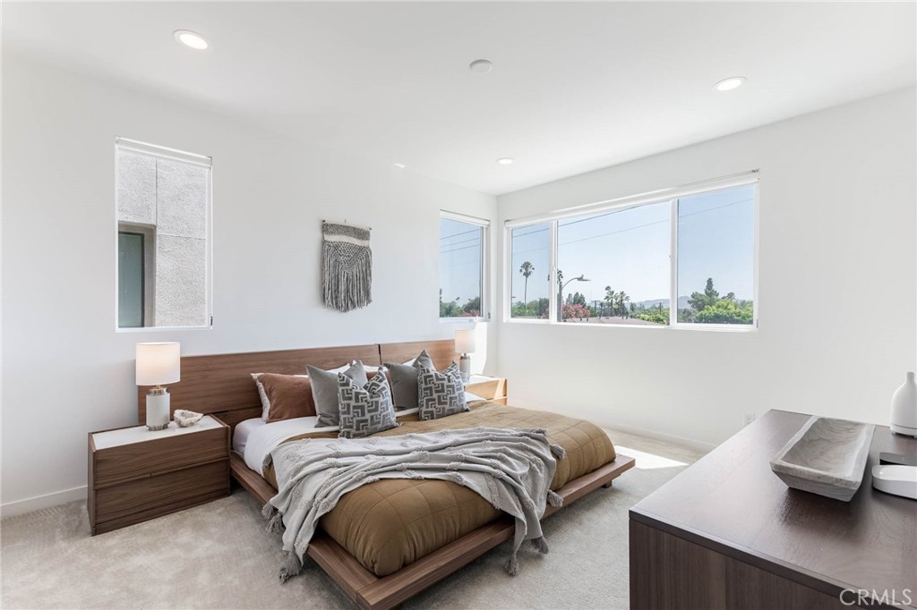 13161 Victory Boulevard Valley Glen, CA 91401 - Photo 19 of 33 a bedroom with a bed and window