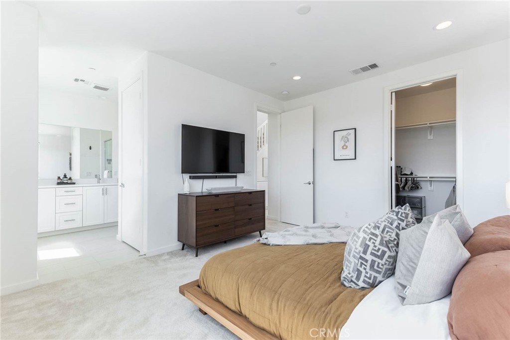 13161 Victory Boulevard Valley Glen, CA 91401 - Photo 20 of 33 a bedroom with a bed and a flat screen tv