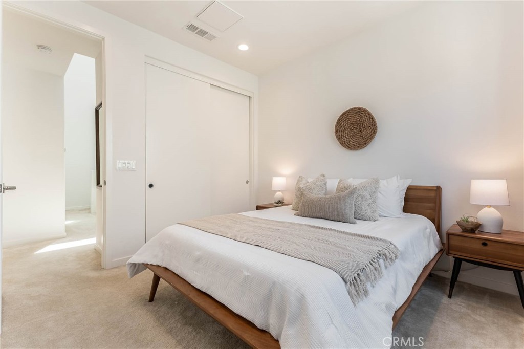 13161 Victory Boulevard Valley Glen, CA 91401 - Photo 22 of 33 a bedroom with a bed and a chandelier