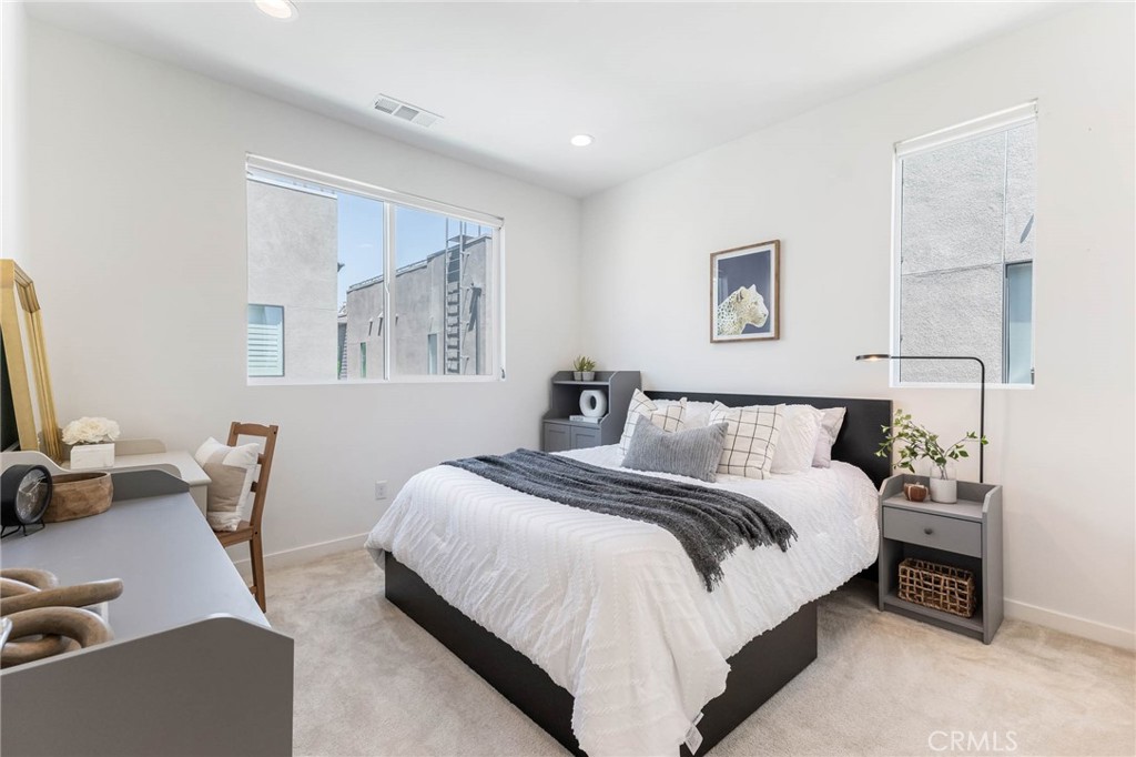 13161 Victory Boulevard Valley Glen, CA 91401 - Photo 24 of 33 a bedroom with bed and a couch