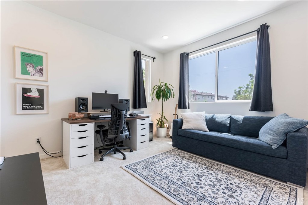 13161 Victory Boulevard Valley Glen, CA 91401 - Photo 26 of 33 a living room with furniture and a flat screen tv