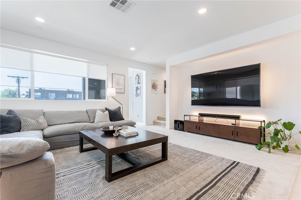 13161 Victory Boulevard Valley Glen, CA 91401 - Photo 9 of 33 a living room with furniture and a flat screen tv