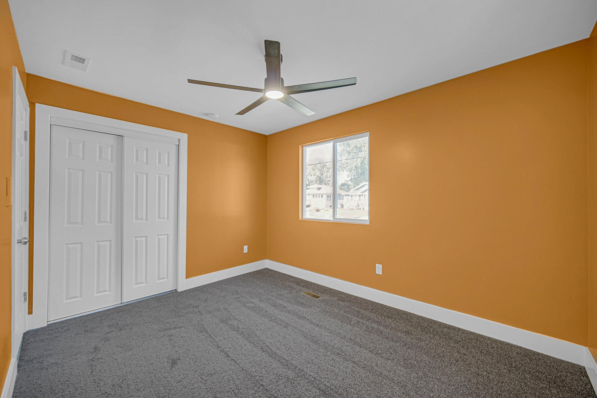 3015 West Ridge Road Hobart, IN 46342 - Photo 14 of 22 an empty room with a window and a ceiling fan